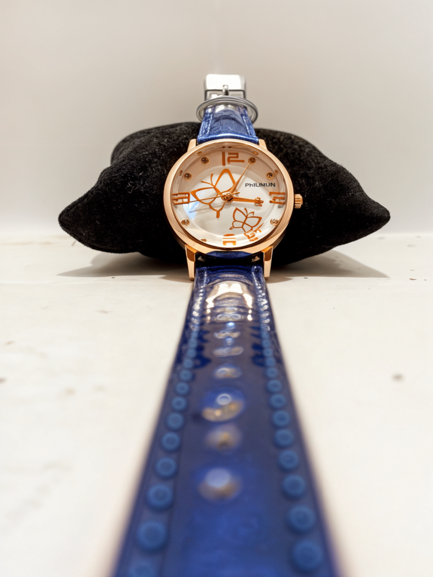 blue watch on black pillow